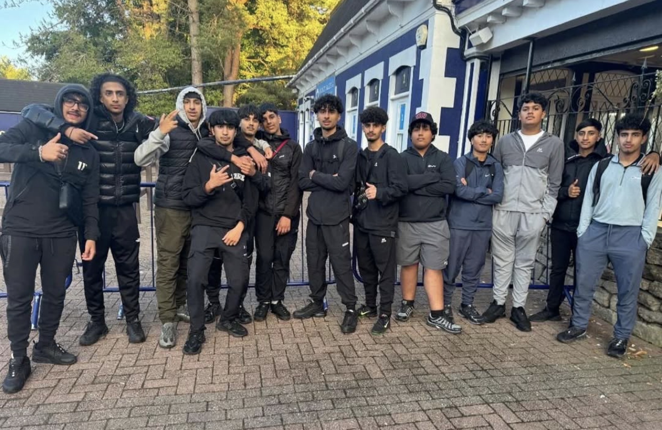 A group of young people standing together outside a building